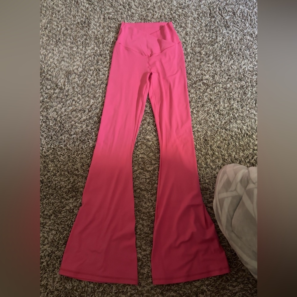 aerie crossover leggings, pink, and are flared at the bottom.